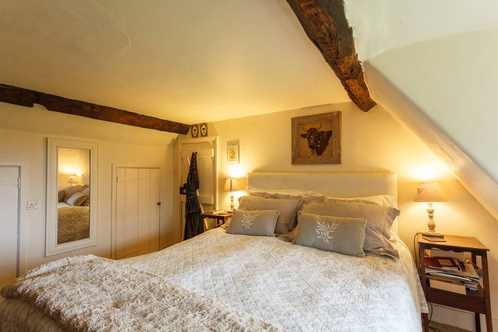 Bedroom with exposed beams and period character
