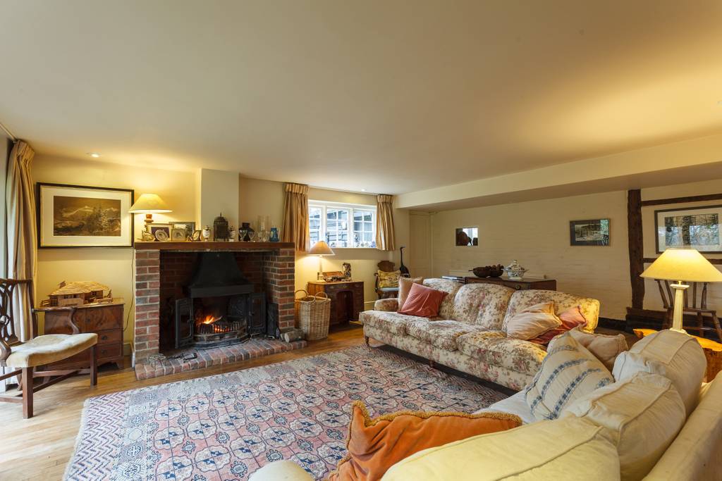 Drawing room with brick fireplace and wood burner
